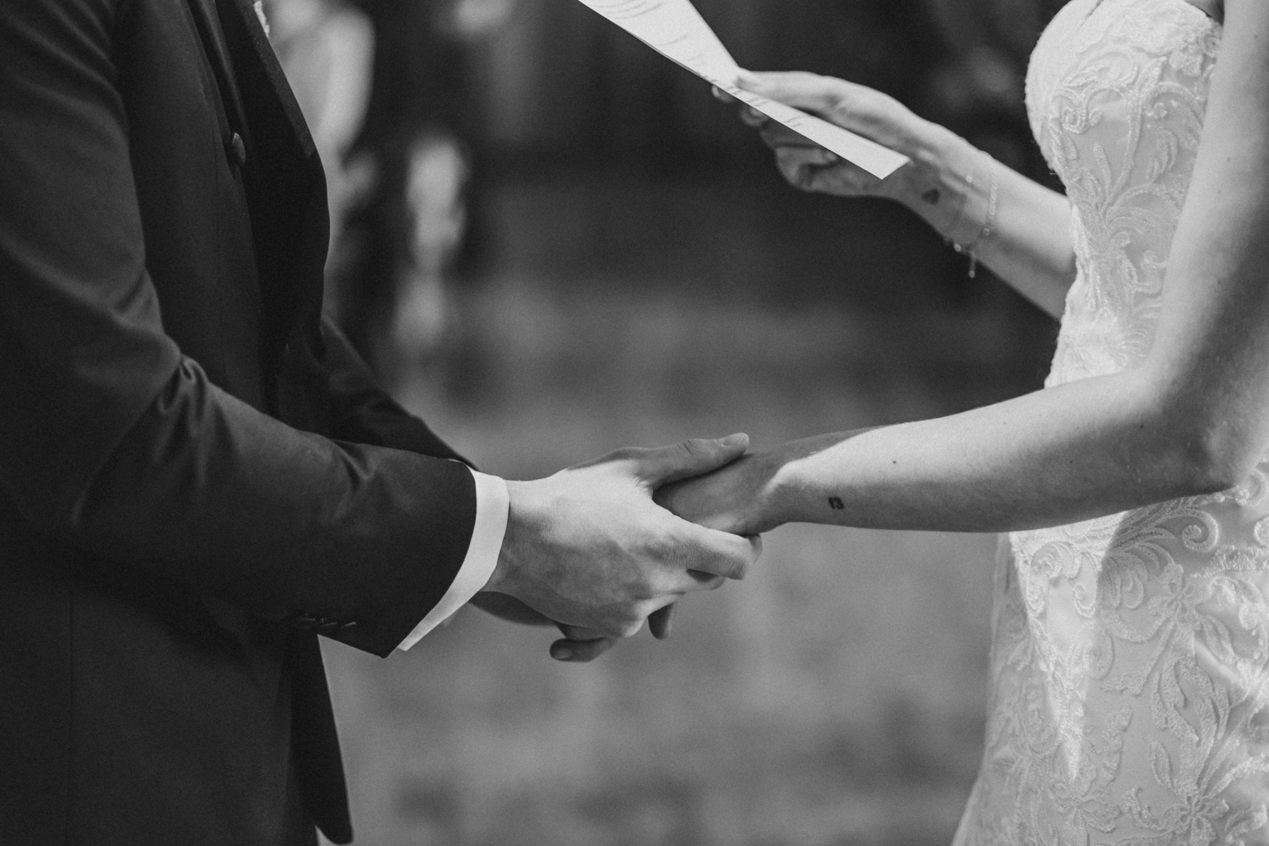 Jess and Tom holding hands during the ceremony