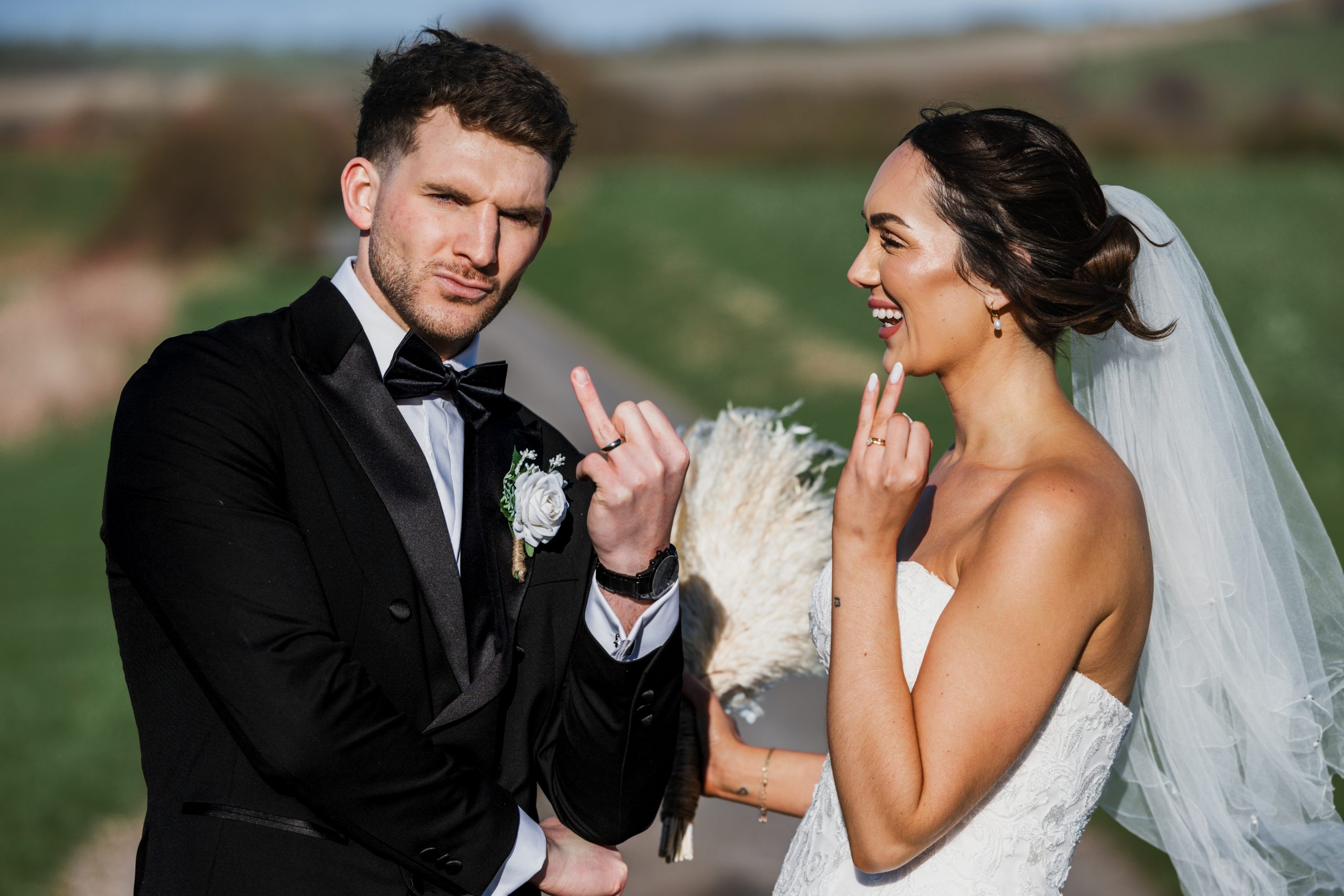 Jess and Tom laughing during their wedding portraits